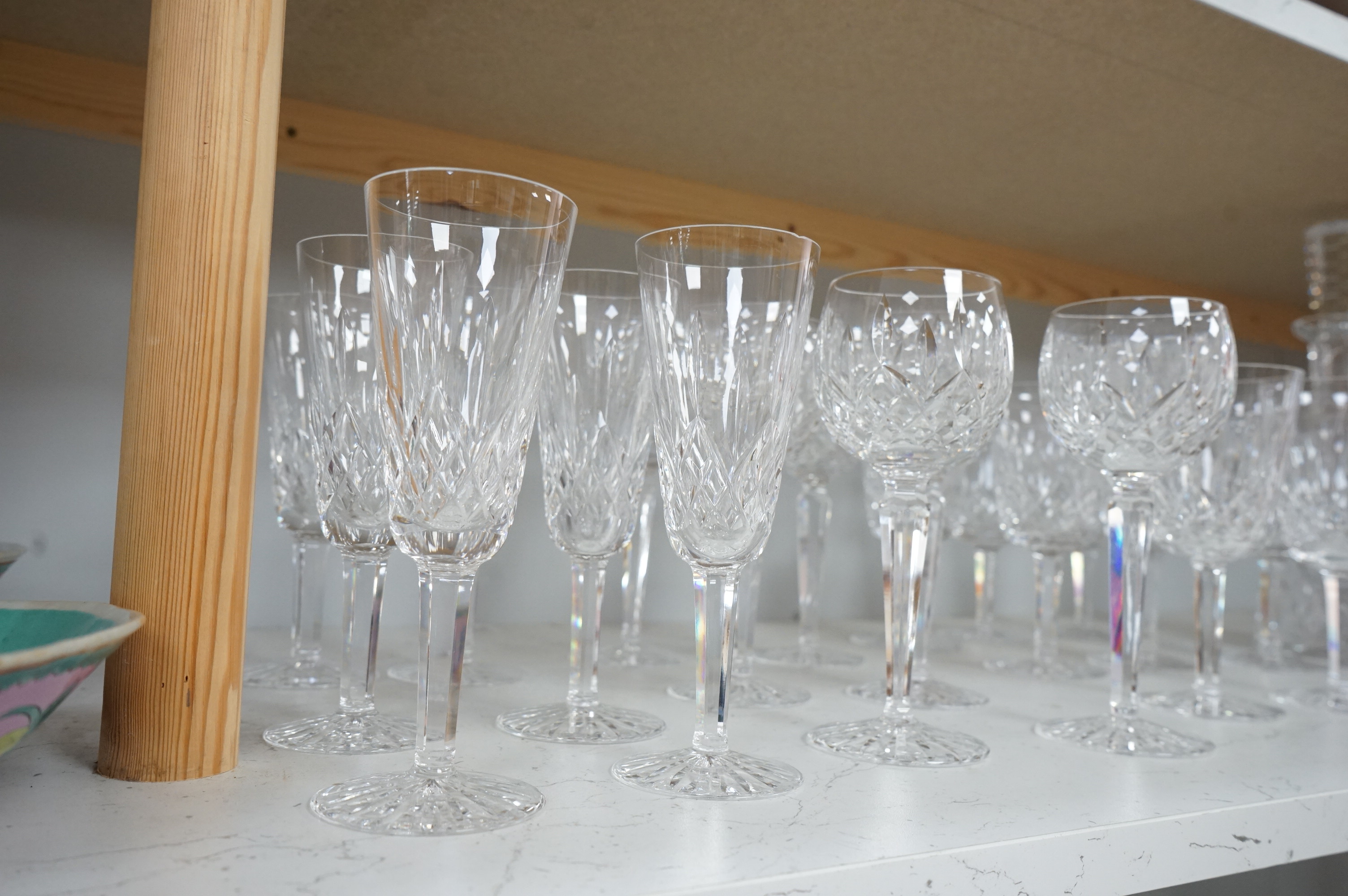 Twenty two Waterford Crystal company wine glasses and a decanter, 33cm